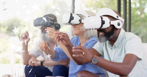 Seniors enjoying virtual reality with VR headsets and playful augmented star graphics
