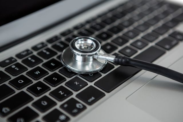 Close-up of a stethoscope placed on a laptop keyboard, symbolizing the intersection of healthcare and technology. Useful for illustrating concepts related to telemedicine, digital health, online consultations, and modern medical diagnostics. Ideal for healthcare technology blogs, medical websites, and presentations on innovation in healthcare.