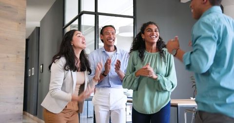 Happy Diverse Team Celebrating Success in Modern Office