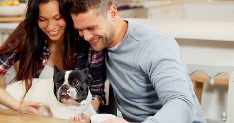 Happy Couple Relaxing with Dog in Comforting Home Atmosphere