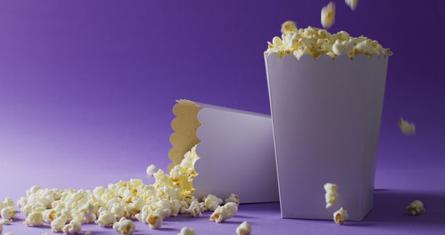 Popcorn Overflowing from White Cardboard Boxes Against Purple - Download Free Stock Images Pikwizard.com