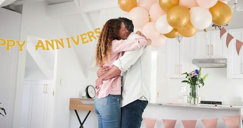 Happy Couple Celebrating Anniversary with Warm Embrace at Home