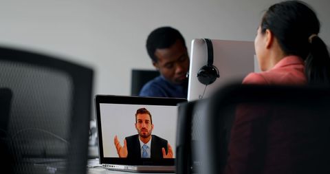 Diverse professionals watching presentation via video call