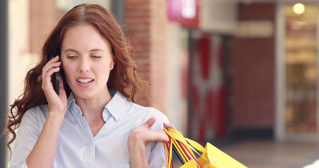 Woman Talking on Phone While Carrying Shopping Bags - Download Free Stock Images Pikwizard.com