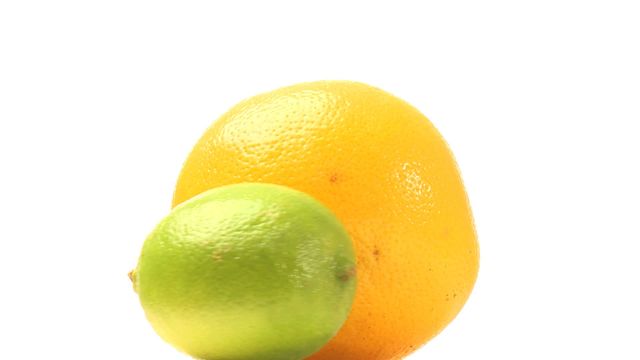 Vibrant lime alongside a juicy grapefruit isolated on a white background emphasizes freshness and simplicity. Perfect for health articles, fruit product promotions, or educational materials on citrus varieties.