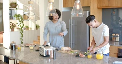 Male Friends Preparing Breakfast in Modern Kitchen Setting