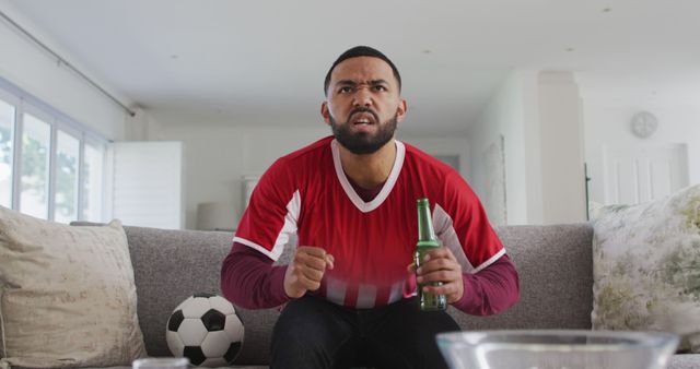 Excited Fan Watching Soccer Match at Home with Beer - Download Free Stock Images Pikwizard.com