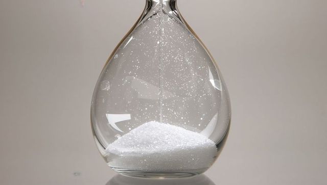 Elegant teardrop glass vessel with granules in minimalist style