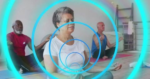 Older adults meditating on yoga mats practicing mindfulness with cyan concentric rings