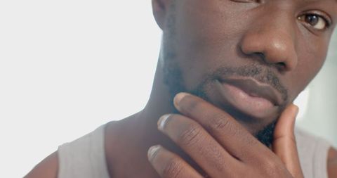 Portrait of a pensive man touching chin wearing silver ring