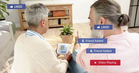 Senior couple measuring blood pressure at home with digital monitor and overlay tags