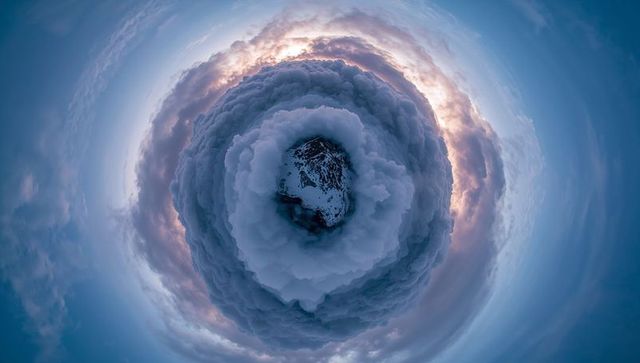 Abstract Swirling Cloudscape Surrounding Snowy Mountain Peak
