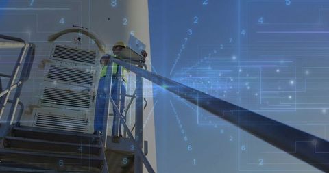 Technician analyzing data on wind turbine platform outdoors