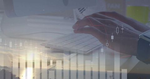 Typing hands on keyboard with financial charts overlaying coastal sunset trading concept