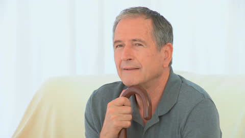 Elderly Man Holding Cane with Relaxed Expression