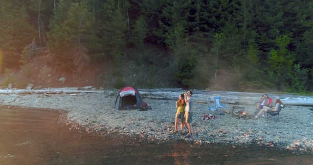 Family Playing Guitar and Roasting Marshmallows During Lakeside Camping - Download Free Stock Photos Pikwizard.com