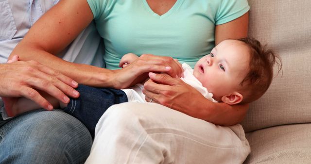 Parents Holding Baby on Couch for Family Bonding - Download Free Stock Images Pikwizard.com