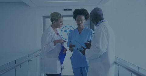 Healthcare professionals discussing patients' health in hospital corridor