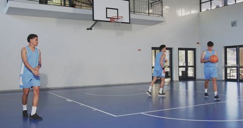 Young athletes practicing basketball on indoor court