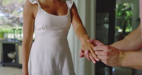 Man Proposing to Joyful Woman at Home