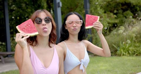 Playful Friends Enjoying Watermelon in Sunny Outdoors