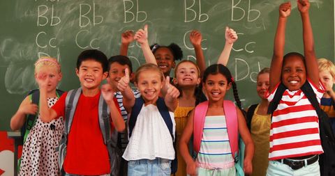 Joyful Schoolchildren Showing Thumbs Up in Classroom Setting - Download Free Stock Images Pikwizard.com
