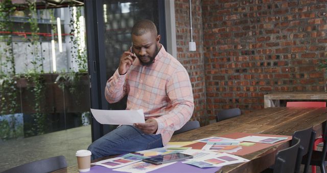 Designer Talking on Phone While Working on Project in Modern Office - Download Free Stock Images Pikwizard.com