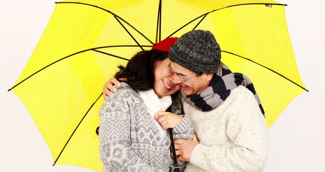 Senior Couple Smiling Under Yellow Umbrella in Cozy Winter Clothing - Download Free Stock Images Pikwizard.com