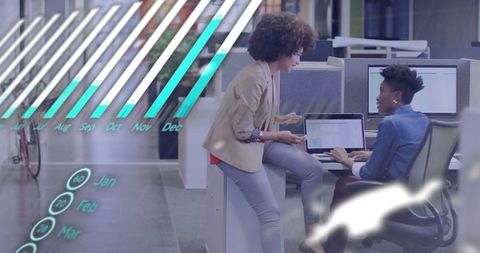 Businesswomen Analyzing Digital Data and Discussing Strategies