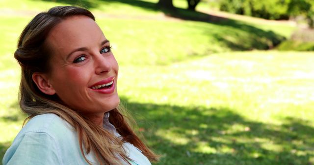 Smiling Woman Relaxing Outdoors on a Sunny Day - Download Free Stock Images Pikwizard.com