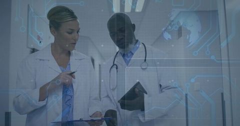 Medical professionals discussing digital diagnostics in hospital