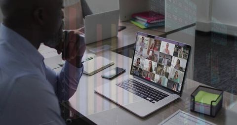 Man joining virtual team meeting on laptop at modern office desk, remote collaboration