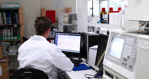 Scientist Analyzing Data Using Laboratory Computer