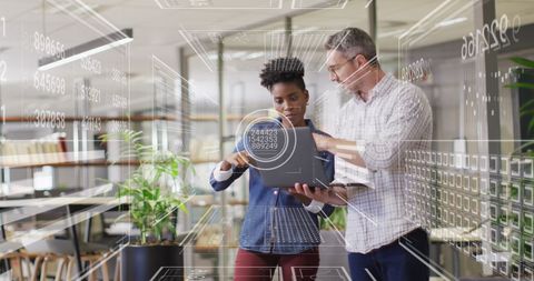 Diverse Colleagues Discussing Financial Data Analysis in Modern Office