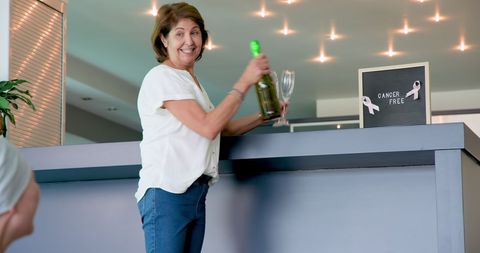 Senior Woman Celebrating Cancer Free News with Champagne