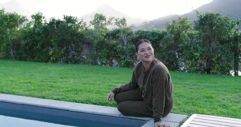 Woman Relaxing by Poolside with Scenic Mountain View
