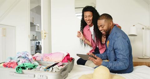 Happy Couple Packing Suitcase for Romantic Vacation