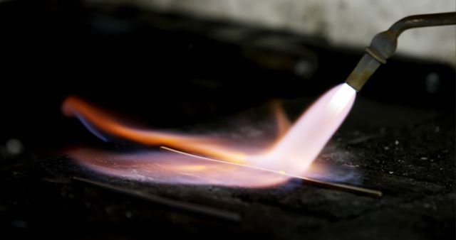 Close-up of welding torch with bright flame heating metal rod - Download Free Stock Images Pikwizard.com