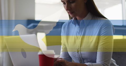 Professional Woman Working on Laptop with Coffee Cup and Peace Symbol
