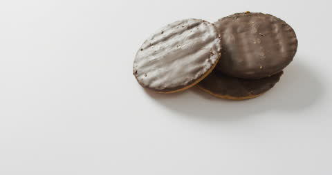 Three Chocolate-Covered Biscuits with Copy Space on White Background
