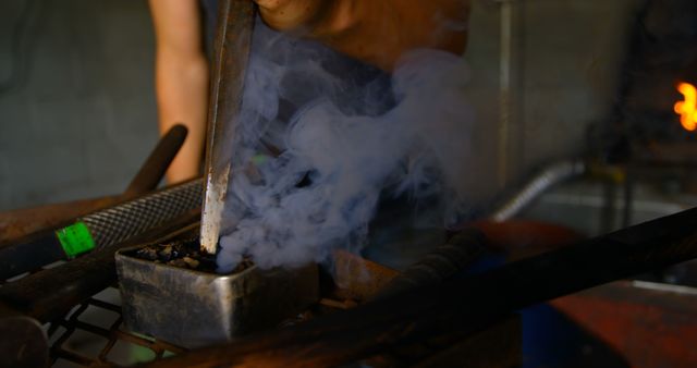 Blacksmith with Smoking Tongs at Work - Download Free Stock Images Pikwizard.com