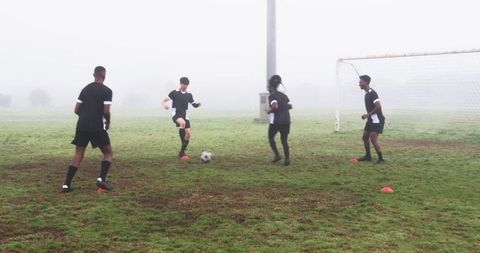 Soccer Team Training on Foggy Field Stressed