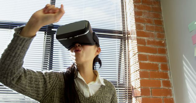 Excited Woman Using Virtual Reality Headset in Office - Download Free Stock Images Pikwizard.com