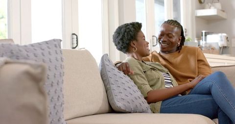 Romantic African American Couple Relaxing on Sofa in Cozy Living Room