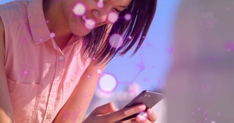 Woman Smiling with Smartphone and Digital Light Effects