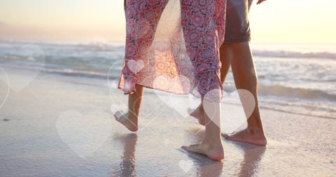 Romantic Interracial Couple Strolling by Ocean at Sunset