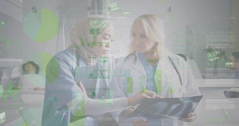 Female Physician and Nurse in Hijab Reviewing Digital Patient Data Using HUD Overlay