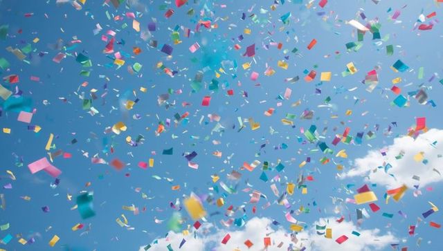Colorful Confetti Falling Against Blue Sky