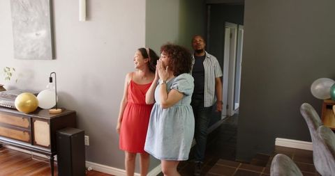Joyful Friends Entering Home for Exciting Housewarming Party