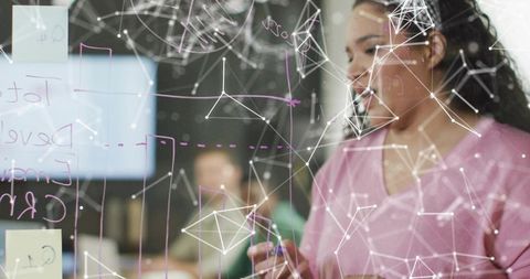 Woman Brainstorming Technological Solutions on Whiteboard
